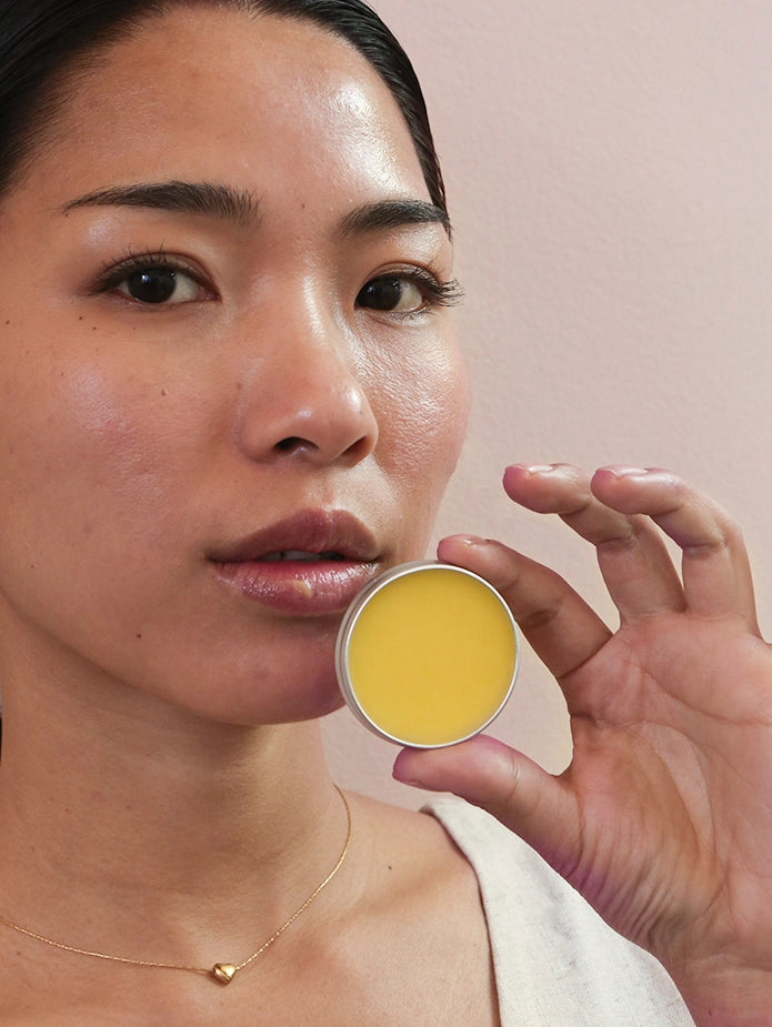 A beautiful lady showing mad honey lip balm