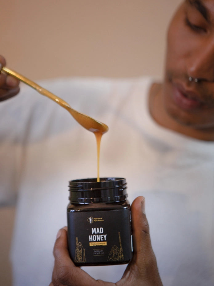 A boy demonstrating the savory mad honey liquid